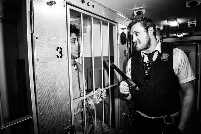 Private Prison Van Escape Game - London Immersive Experience - Prison Van Set-Up: Orange Gear, Cuffs, and Maximum-Security Vibes